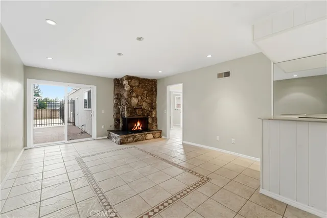 a view of a room with gym equipment and mirror