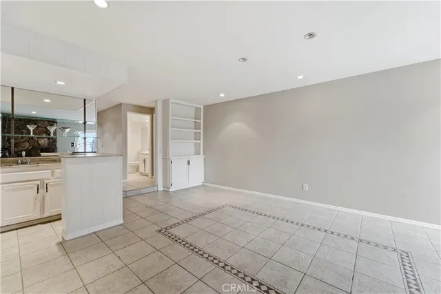 a view of a livingroom with wooden floor and a ceiling fan
