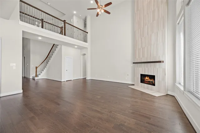 a view of a livingroom with wooden floor and a fireplace
