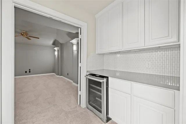 a view of staircase with railing and white walls