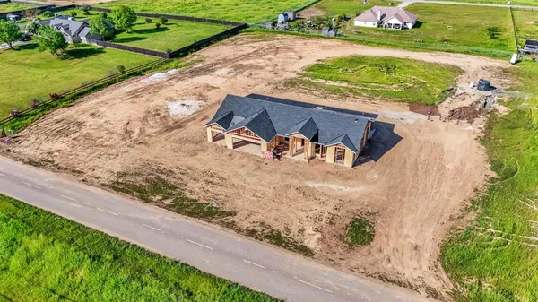 a view of a yard with wooden fence