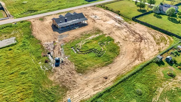 a wooden bench sitting in the middle of a yard