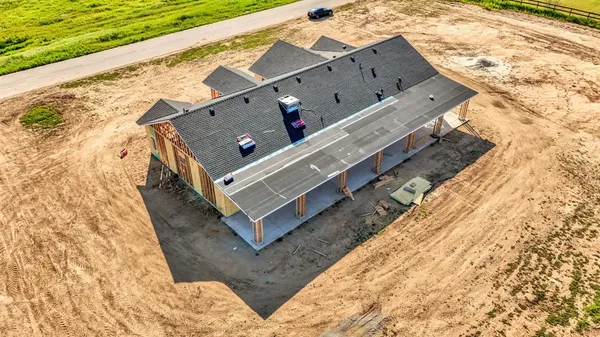 an aerial view of a house with backyard