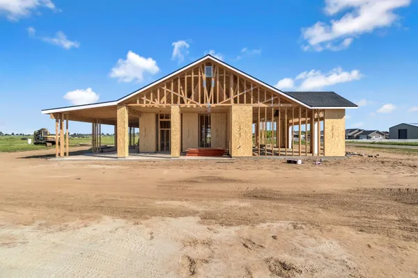 a view of a house next to a yard