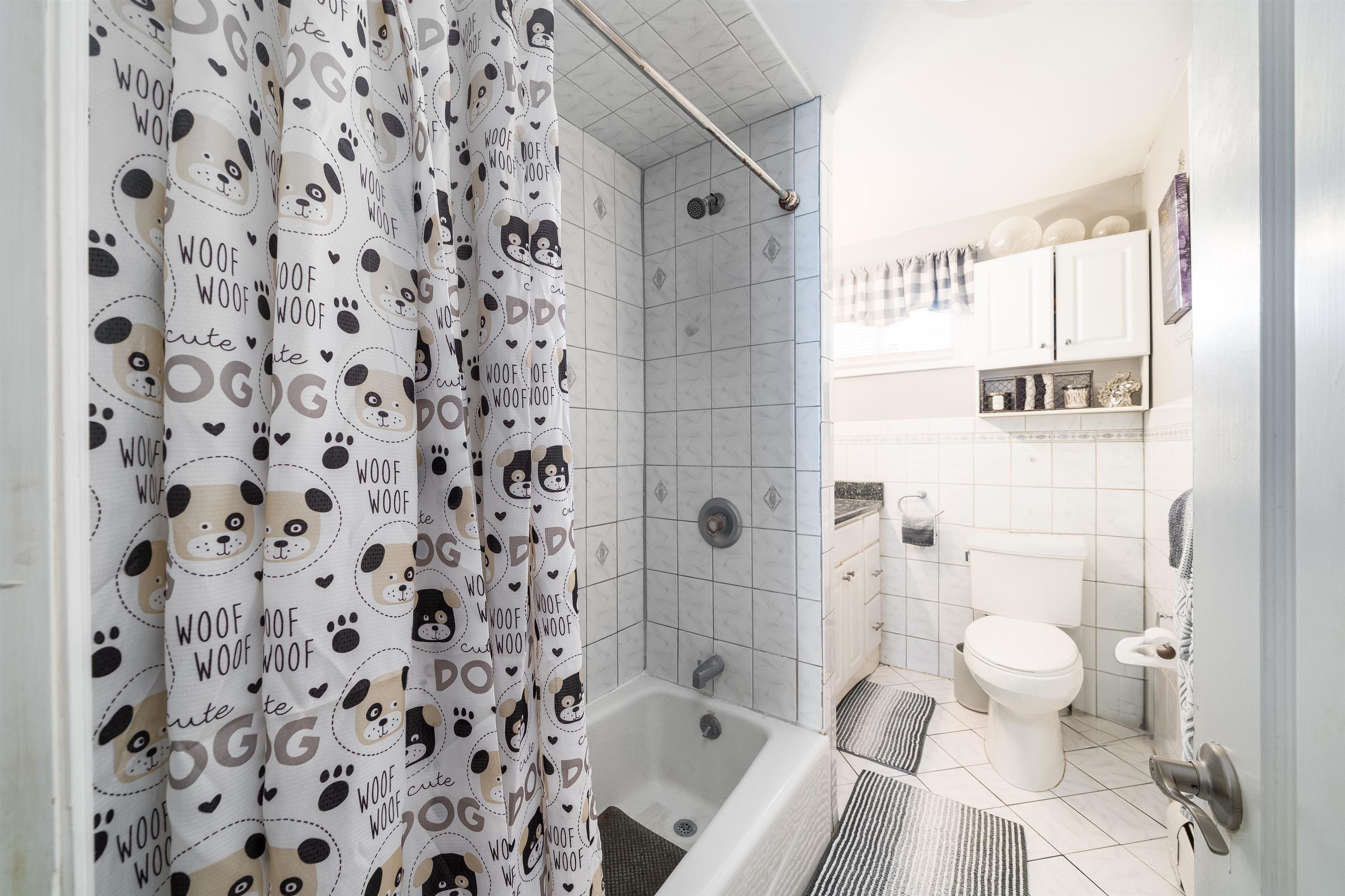 33 South Road Wayne, NJ 07470 - Photo 7 of 22 a bathroom with a bathtub and a shower curtain