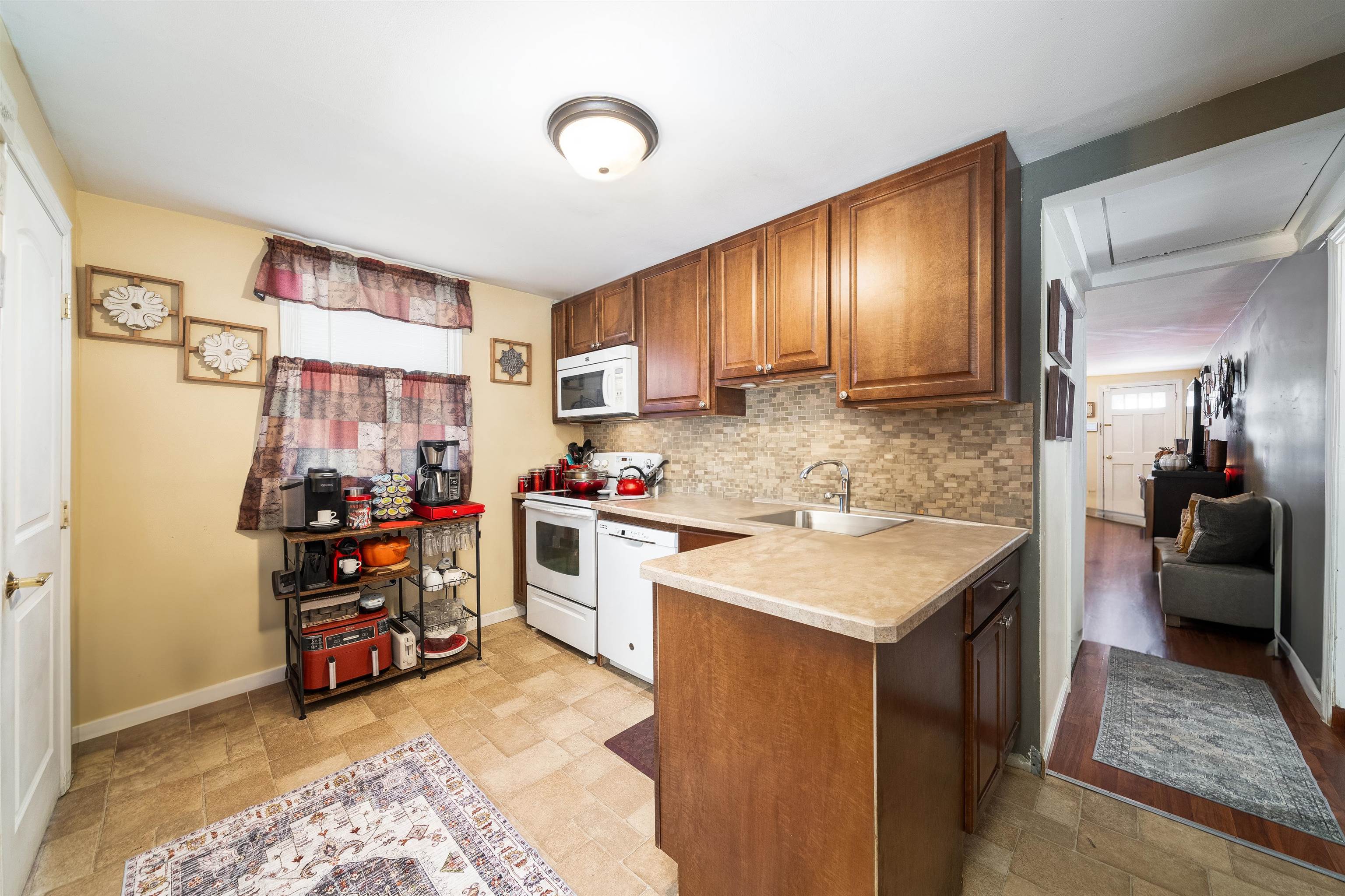 33 South Road Wayne, NJ 07470 - Photo 8 of 22 a kitchen with kitchen island granite countertop a sink stove and cabinets