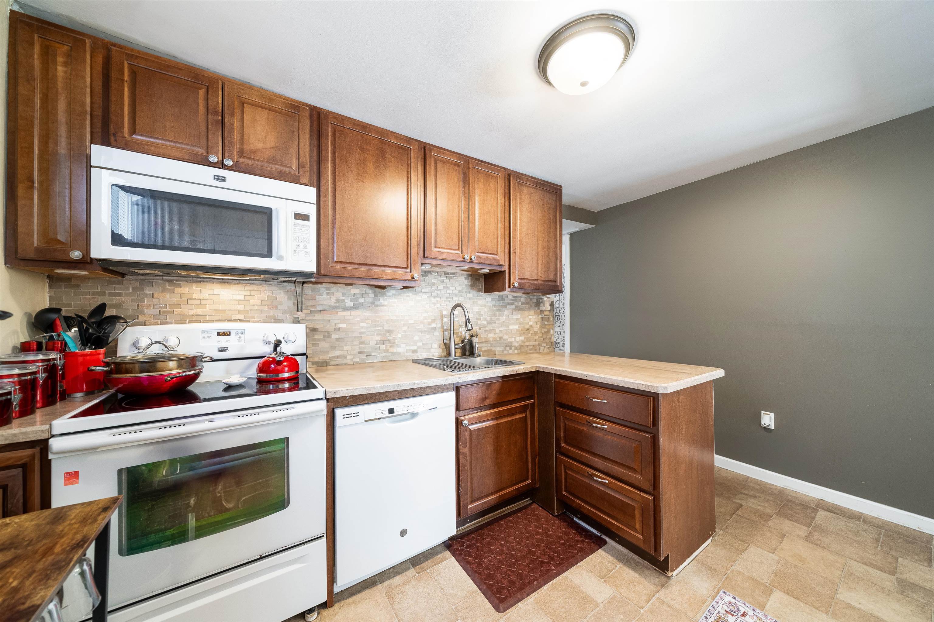 33 South Road Wayne, NJ 07470 - Photo 10 of 22 a kitchen with cabinets a sink and appliances