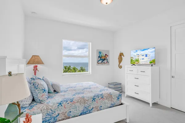 a view of empty room with toys and dresser