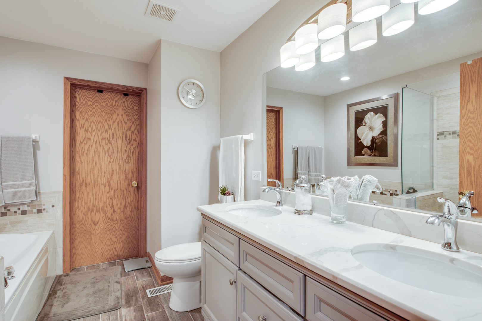 239 Springbrook Trail South Oswego, IL 60543 - Photo 14 of 20 a bathroom with a double vanity sink toilet and shower