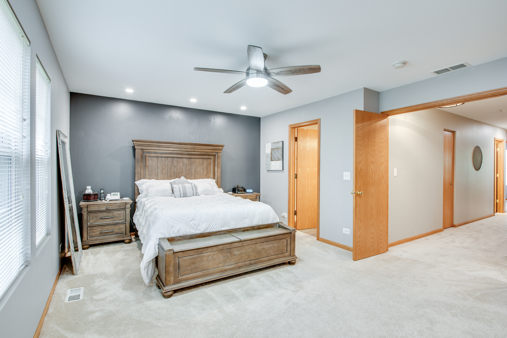 239 Springbrook Trail South Oswego, IL 60543 - Photo 16 of 20 a spacious bedroom with a bed and a chandelier