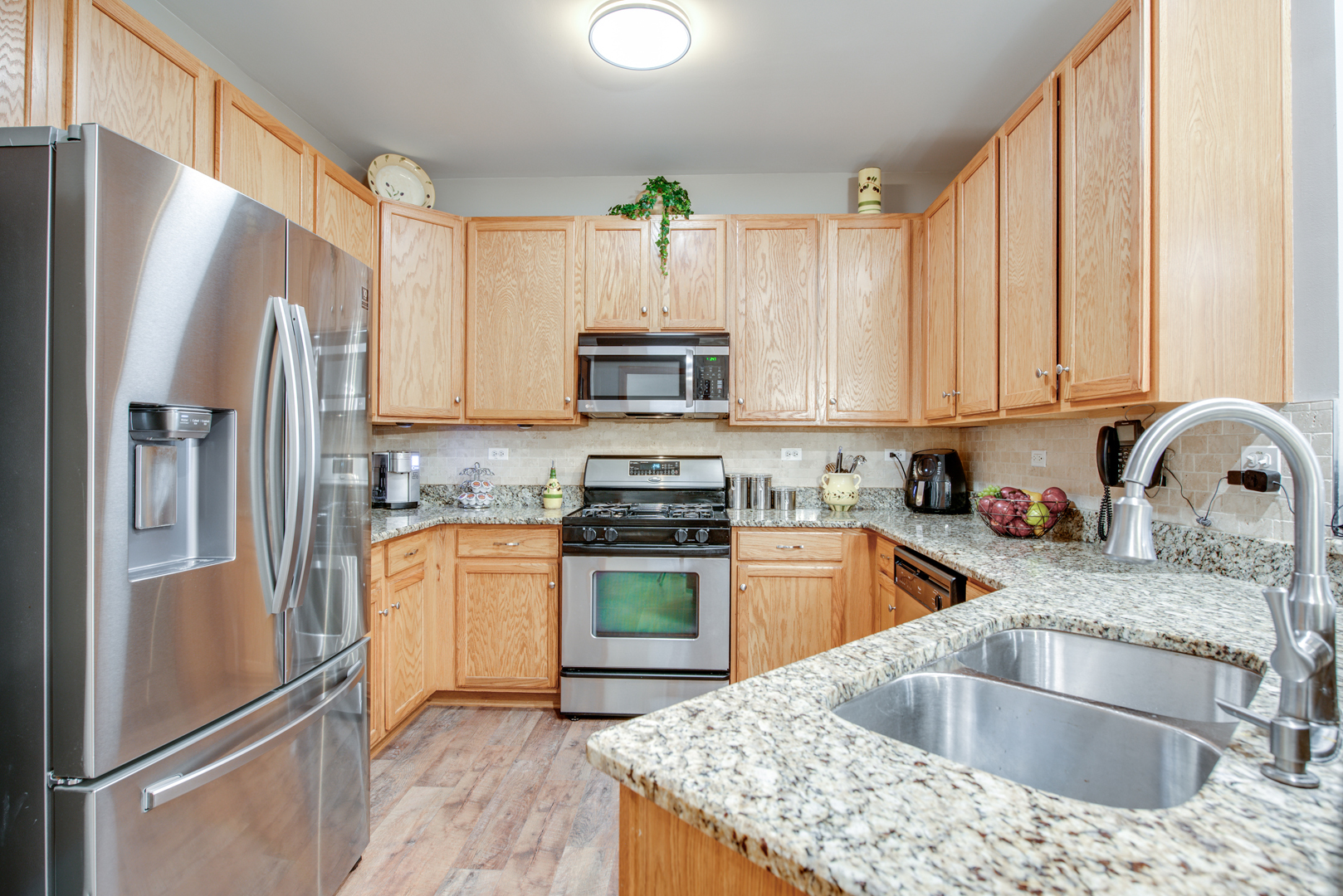 239 Springbrook Trail South Oswego, IL 60543 - Photo 8 of 20 a kitchen with granite countertop a refrigerator stove and sink