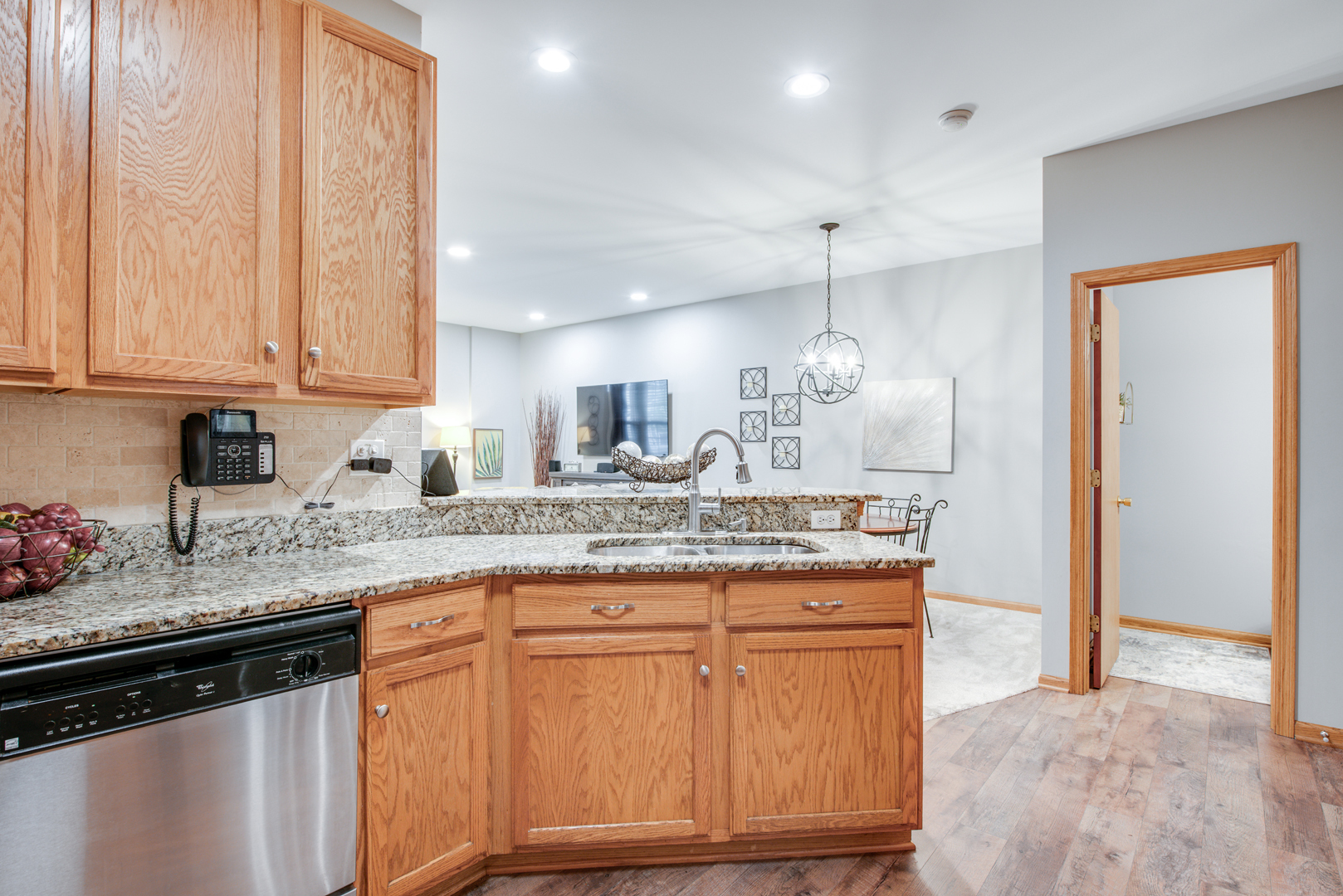 239 Springbrook Trail South Oswego, IL 60543 - Photo 9 of 20 a kitchen with granite countertop a sink and cabinets