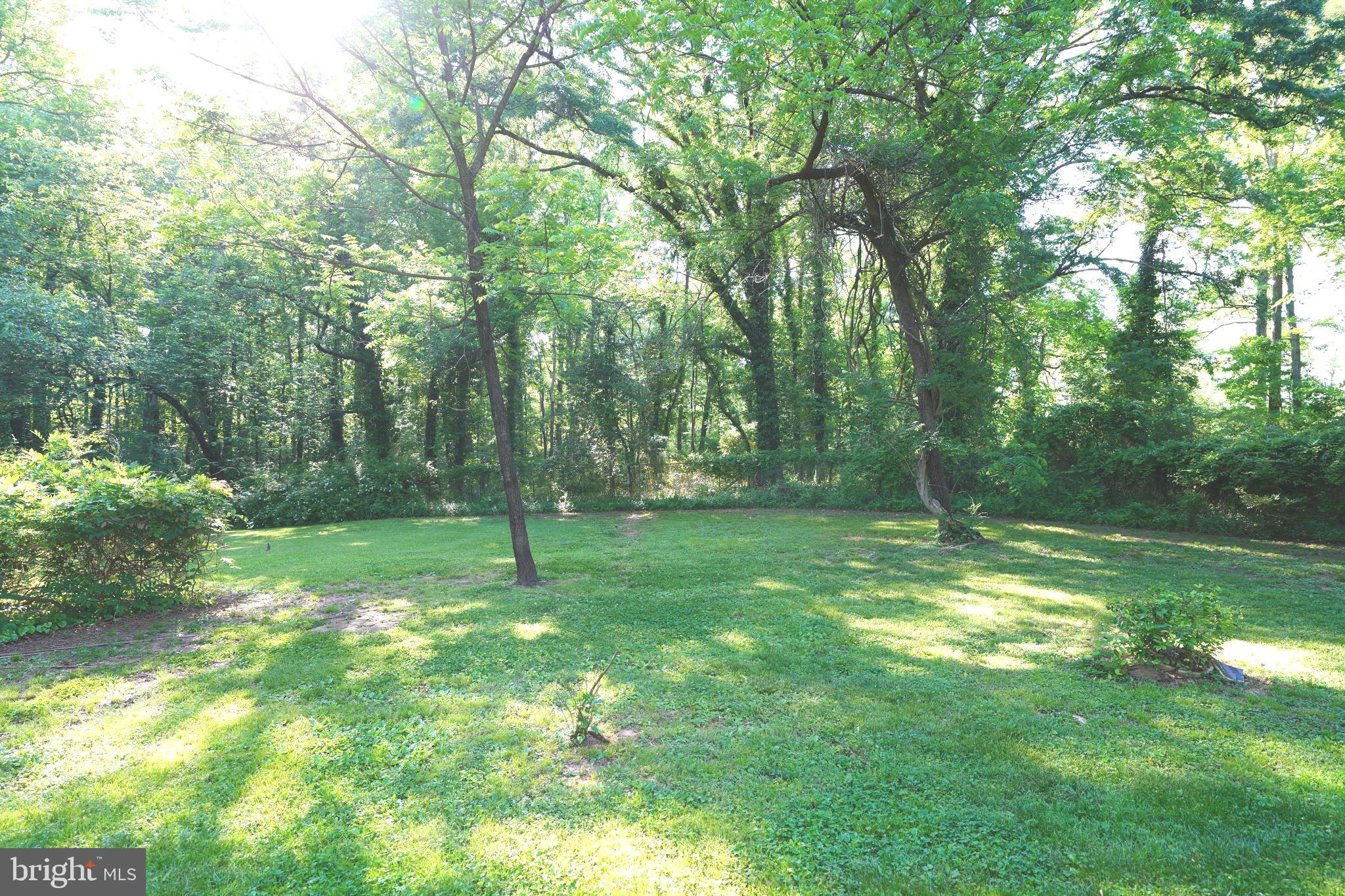 Greenbelt Road Lanham, MD 20706 - Photo 1 of 74 a backyard of a house with lots of green space and fountain