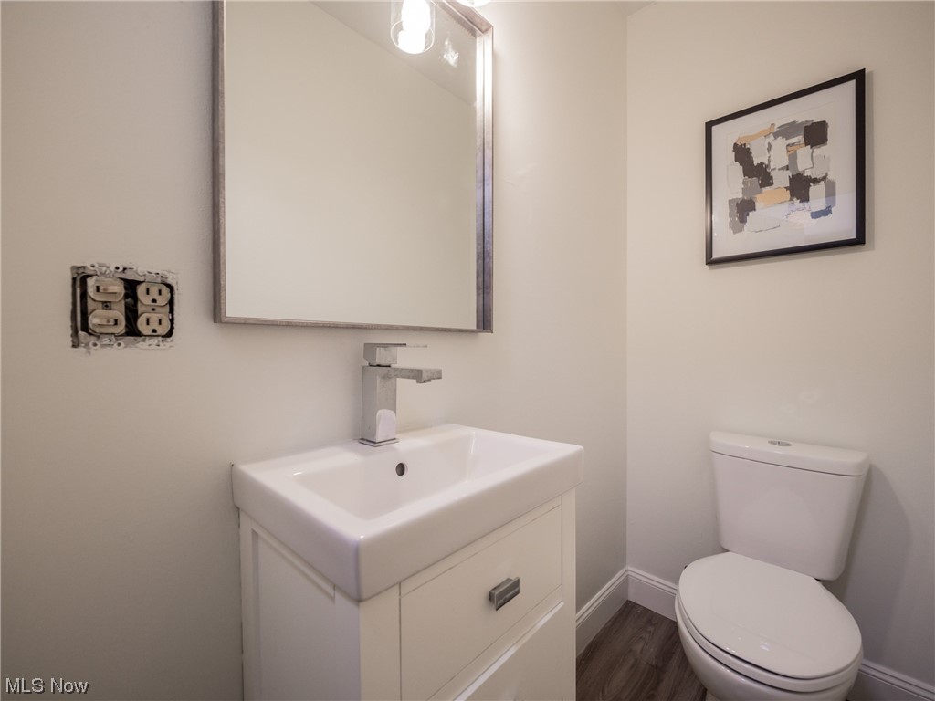 4746 Farnhurst Road Cleveland, OH 44124 - Photo 23 of 29 Bathroom featuring wood-type flooring, toilet, and vanity