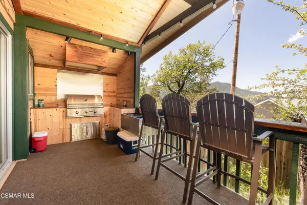 a view of a porch with furniture and a yard