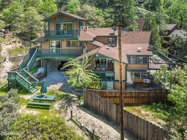 a aerial view of a house with wooden fence