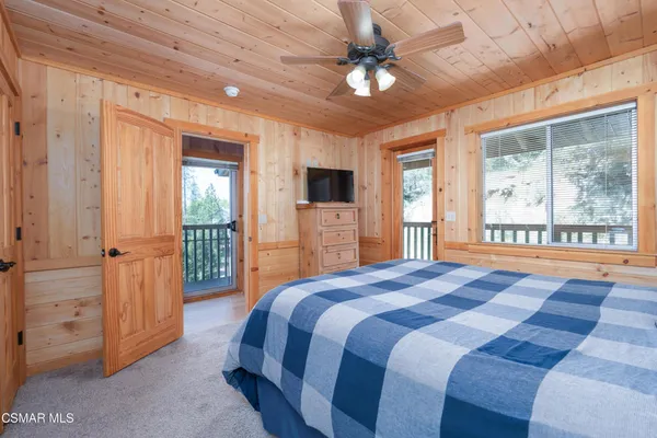 a spacious bedroom with a large bed and a tv