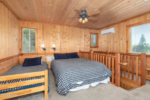 a bedroom with a bed and a large window with balcony view