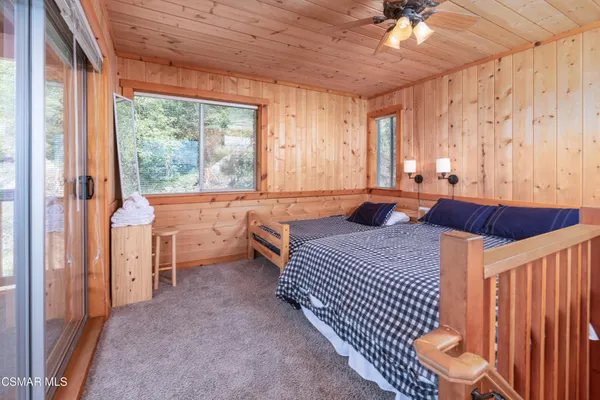 a bedroom with furniture and a large window