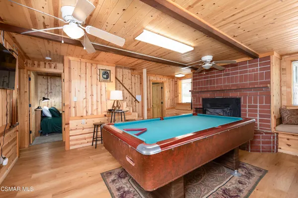 a room with pool table and windows