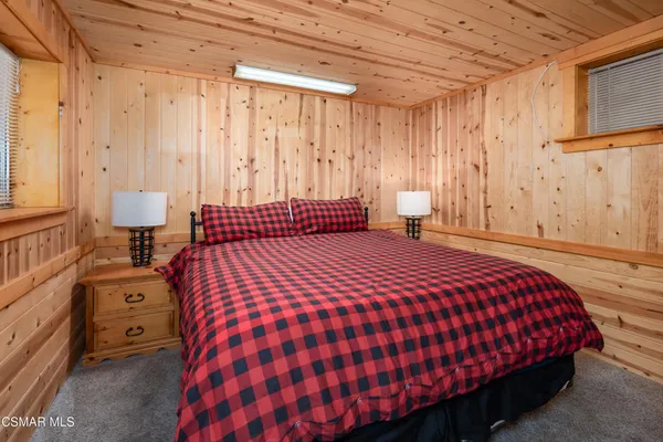 a bedroom with a bed and a night stand