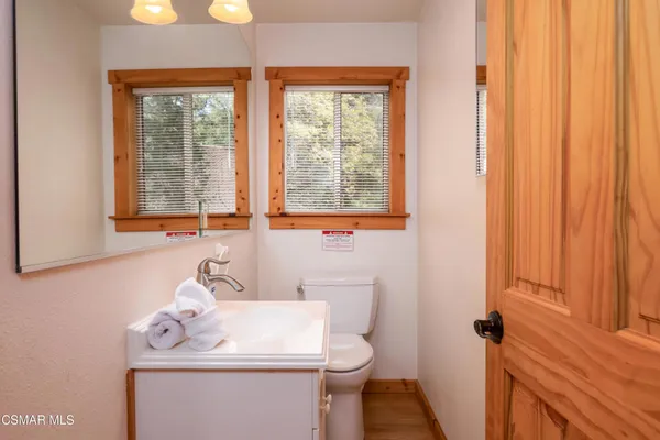 a bathroom with a sink a toilet and a window