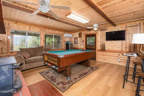 a living room with furniture a flat screen tv and a table