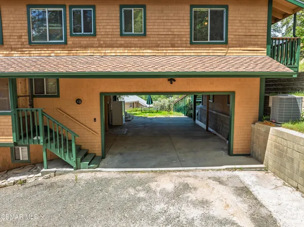 a view of a house with a wooden fence