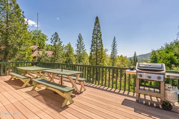 a view of a balcony with wooden floor and outdoor space