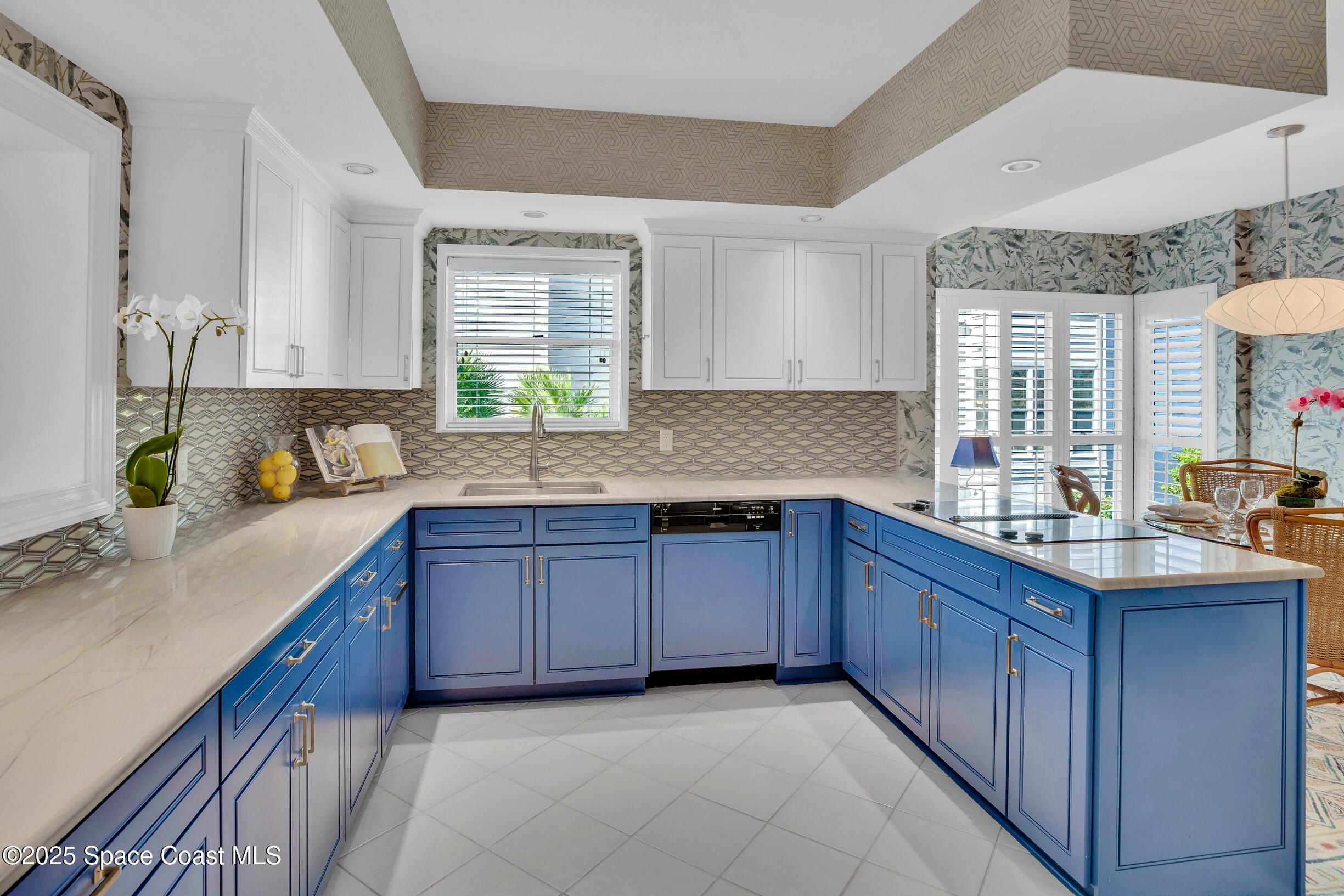 1903 Bay Road, Unit 205 Vero Beach, FL 32963 - Photo 11 of 53 a kitchen with granite countertop a sink stove and cabinets
