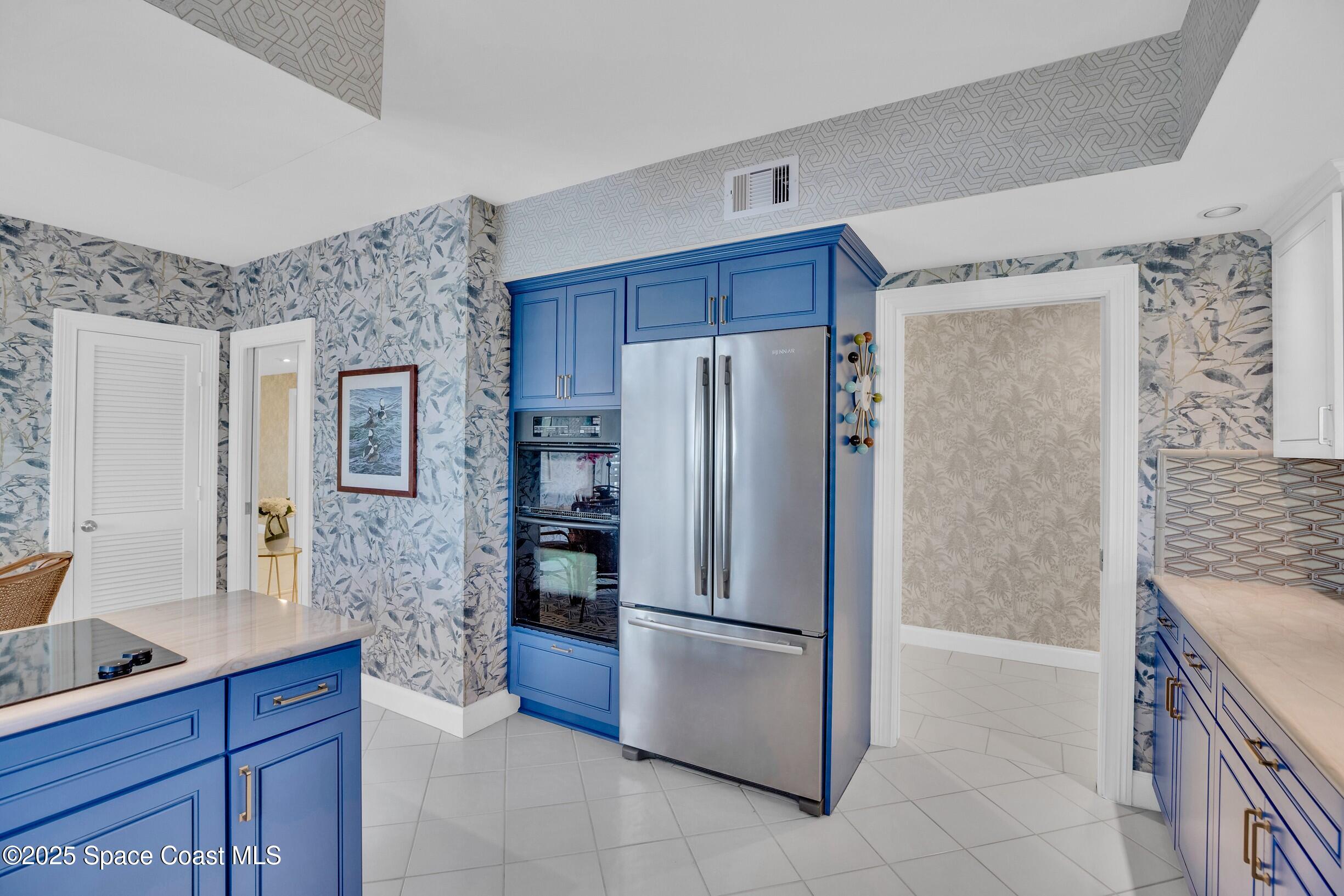 1903 Bay Road, Unit 205 Vero Beach, FL 32963 - Photo 12 of 53 a kitchen with stainless steel appliances granite countertop a refrigerator and a stove