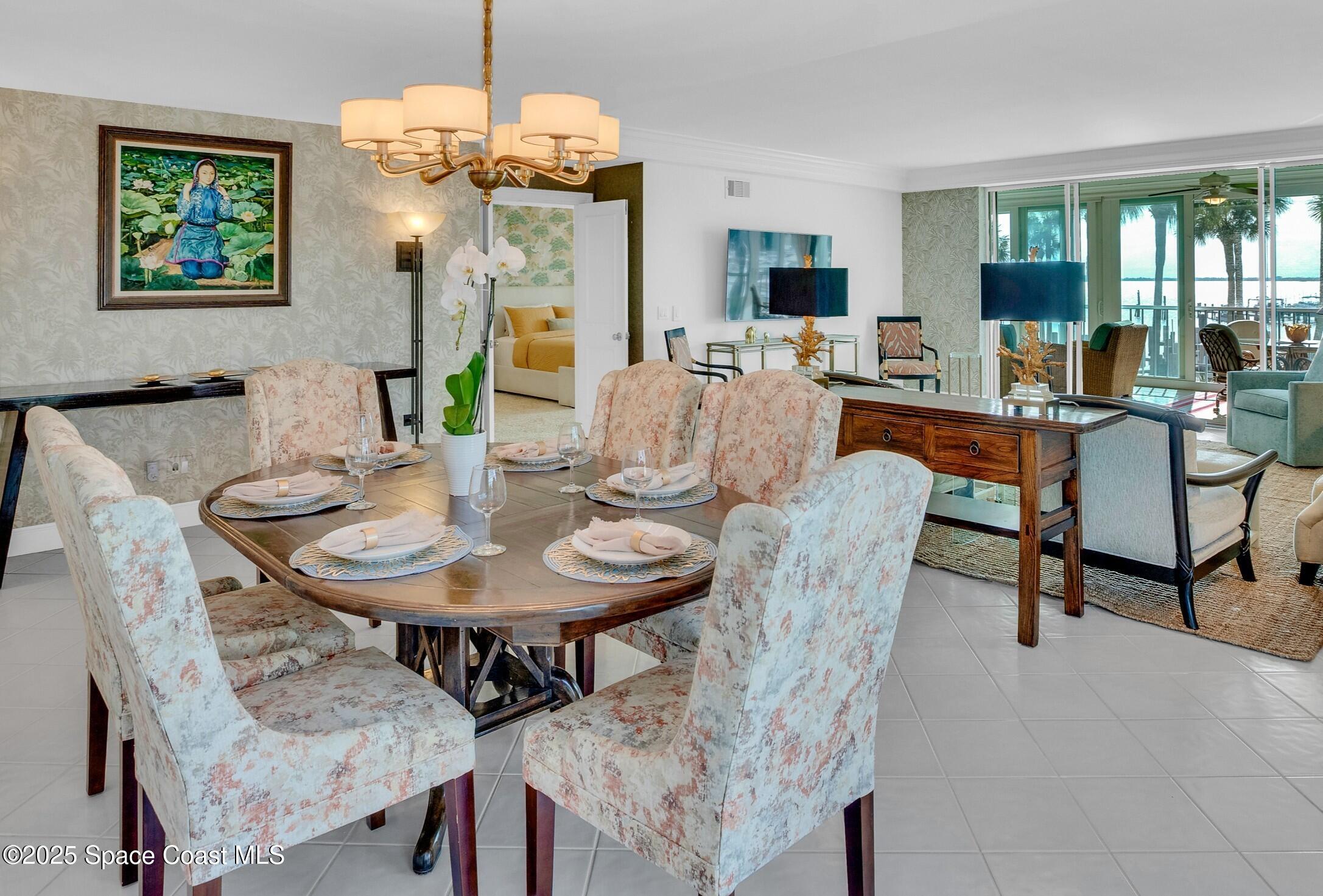 1903 Bay Road, Unit 205 Vero Beach, FL 32963 - Photo 15 of 53 a view of a dining room with furniture and a chandelier
