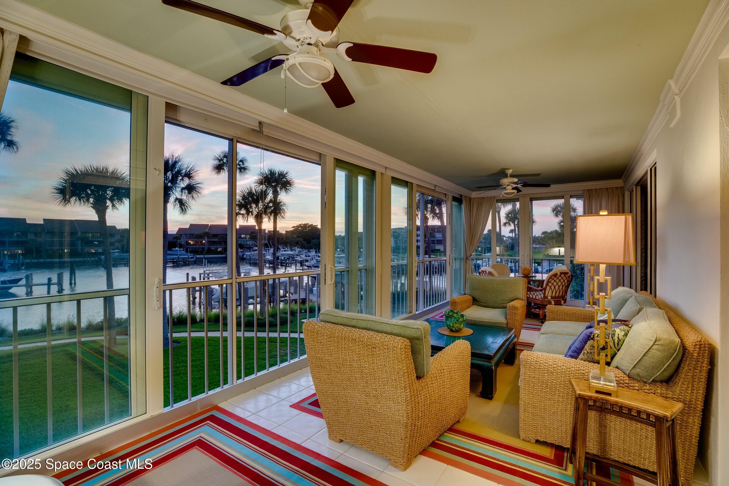 1903 Bay Road, Unit 205 Vero Beach, FL 32963 - Photo 20 of 53 a living room with patio furniture and a floor to ceiling window