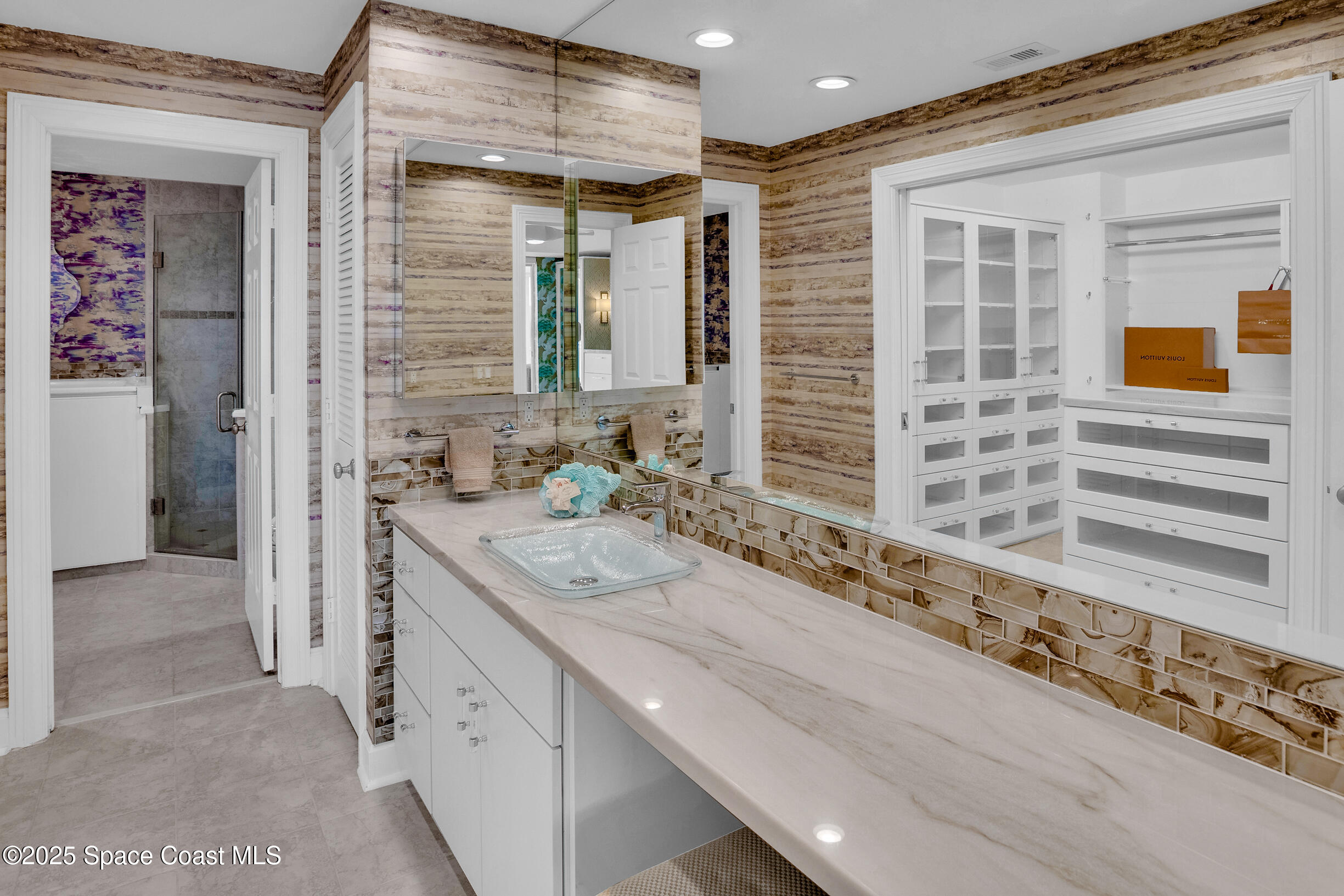1903 Bay Road, Unit 205 Vero Beach, FL 32963 - Photo 26 of 53 a bathroom with a granite countertop sink and a shower
