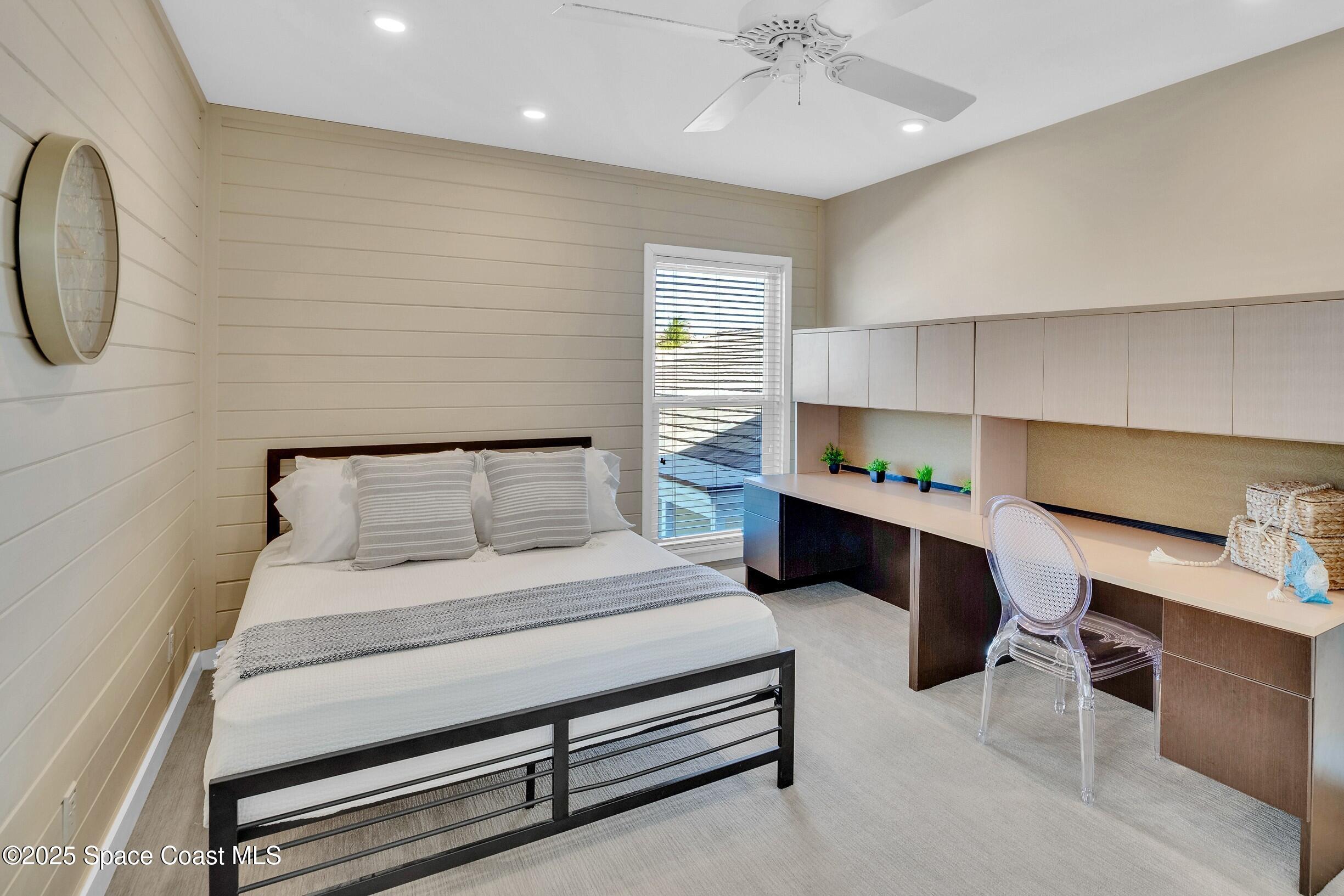1903 Bay Road, Unit 205 Vero Beach, FL 32963 - Photo 34 of 53 a bedroom with a bed a desk and chair