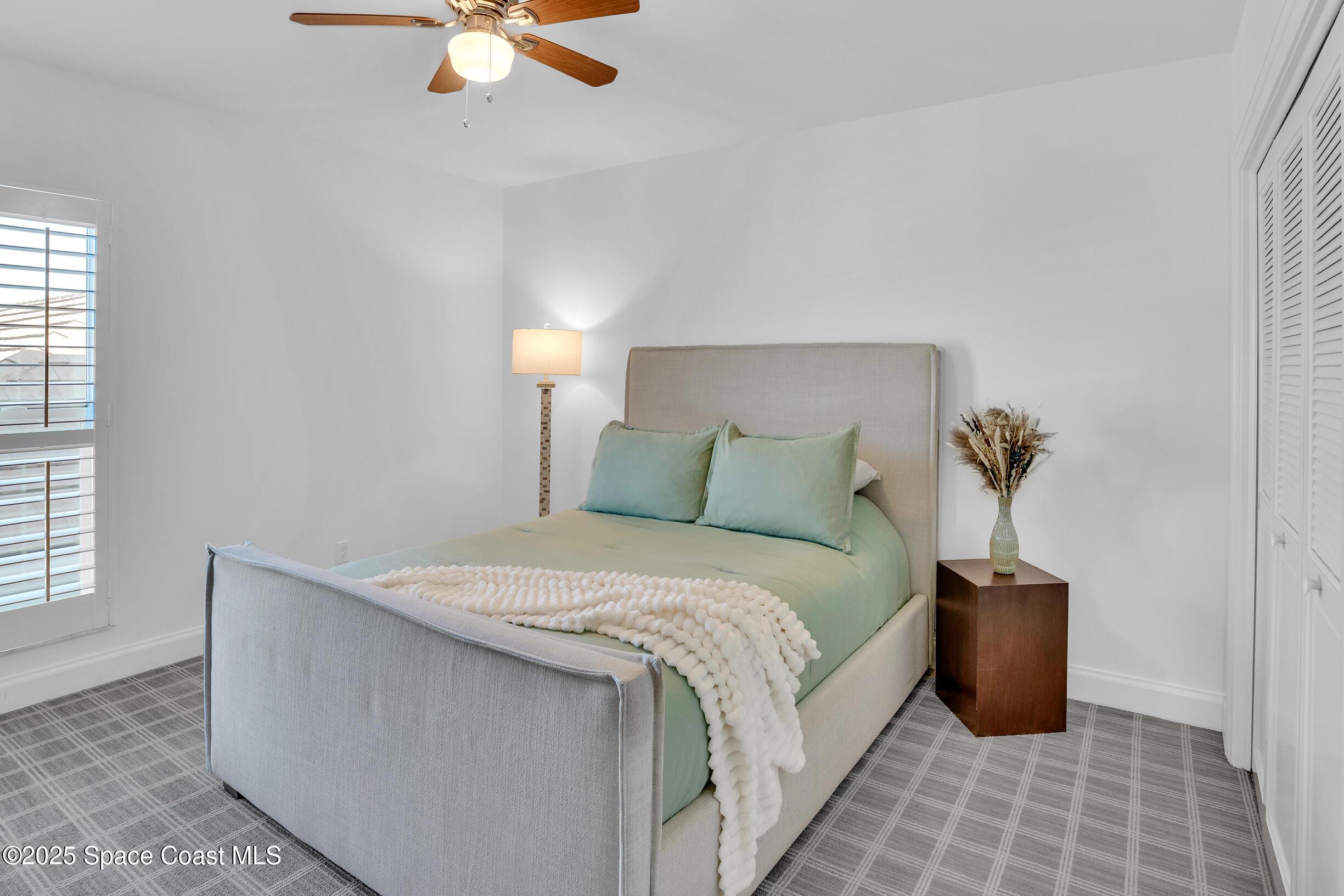 1903 Bay Road, Unit 205 Vero Beach, FL 32963 - Photo 37 of 53 a bedroom with bed and a window