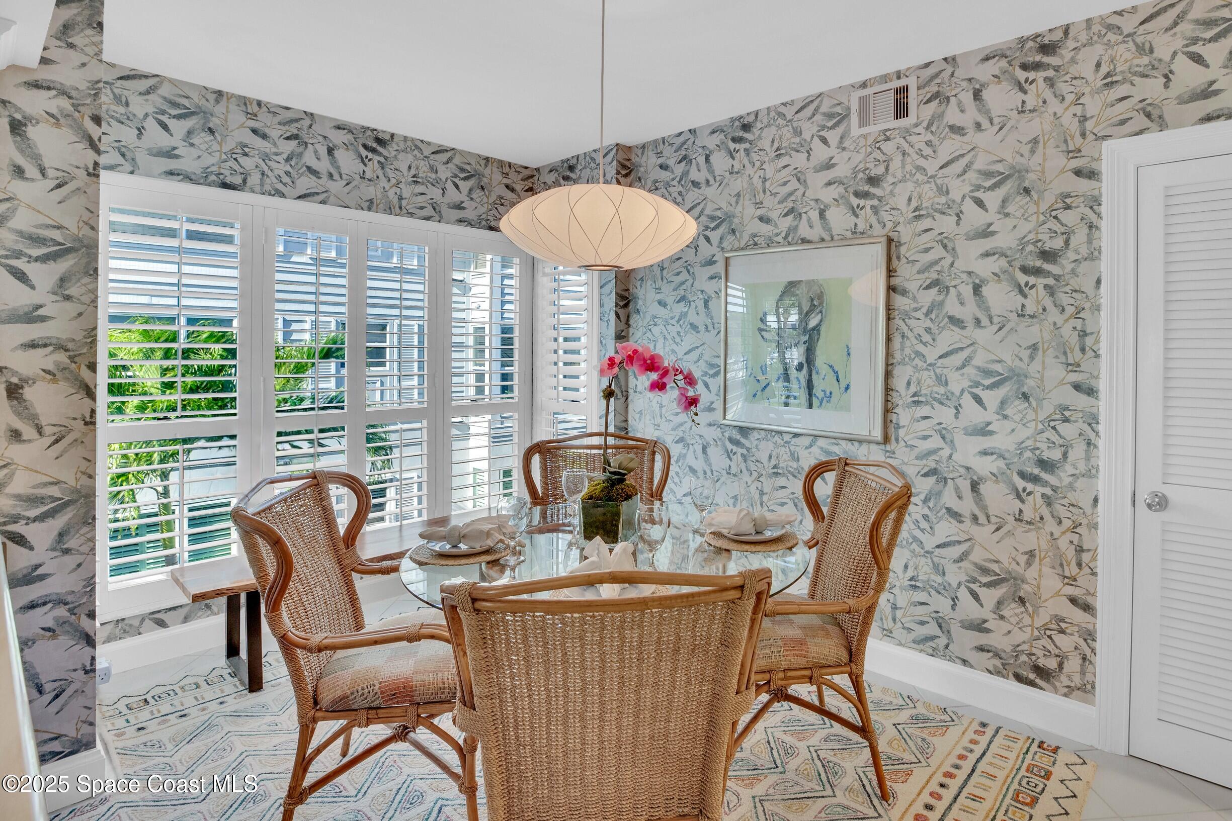 1903 Bay Road, Unit 205 Vero Beach, FL 32963 - Photo 8 of 53 a dining room with furniture and a floor to ceiling window