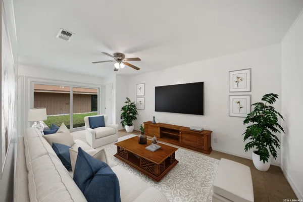 a living room with furniture and a flat screen tv