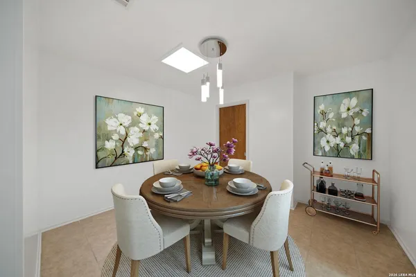 a view of a dining room with furniture and a chandelier