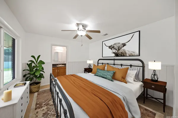 a bedroom with a large bed and a chandelier