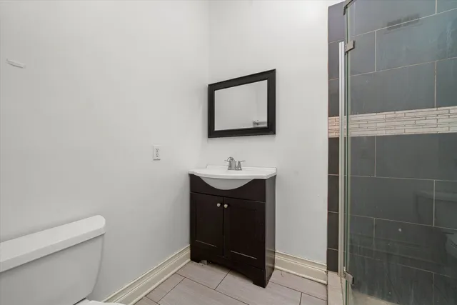 a bathroom with a sink a toilet and a mirror