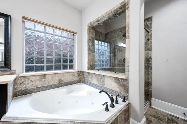 a bathroom with a bathtub and a window