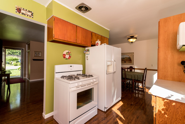 22 Durango Road Montgomery, IL 60538 - Photo 4 of 25 a kitchen with a refrigerator a stove and wooden floor