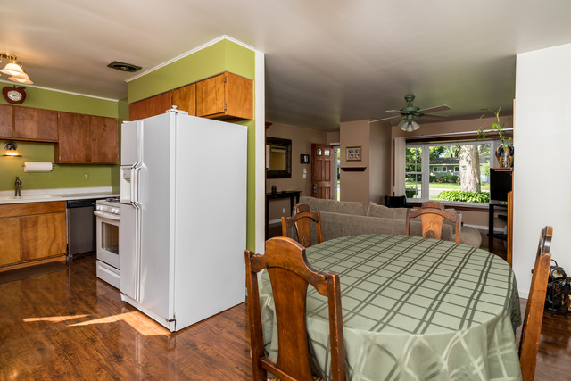 22 Durango Road Montgomery, IL 60538 - Photo 7 of 25 a kitchen with stainless steel appliances a refrigerator a stove a sink a dining table and chairs