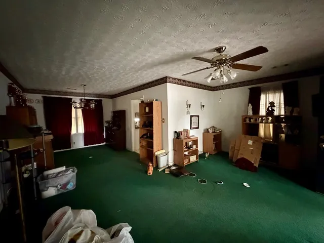a living room with furniture a window and gym equipment