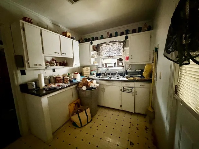a kitchen with sink cabinets and appliances