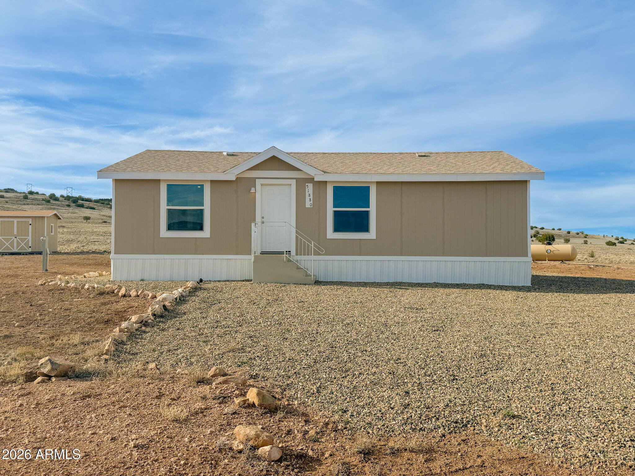 51880 North Gold Plains Road Seligman, AZ 86337 - Photo 3 of 24 a front view of a house with a yard