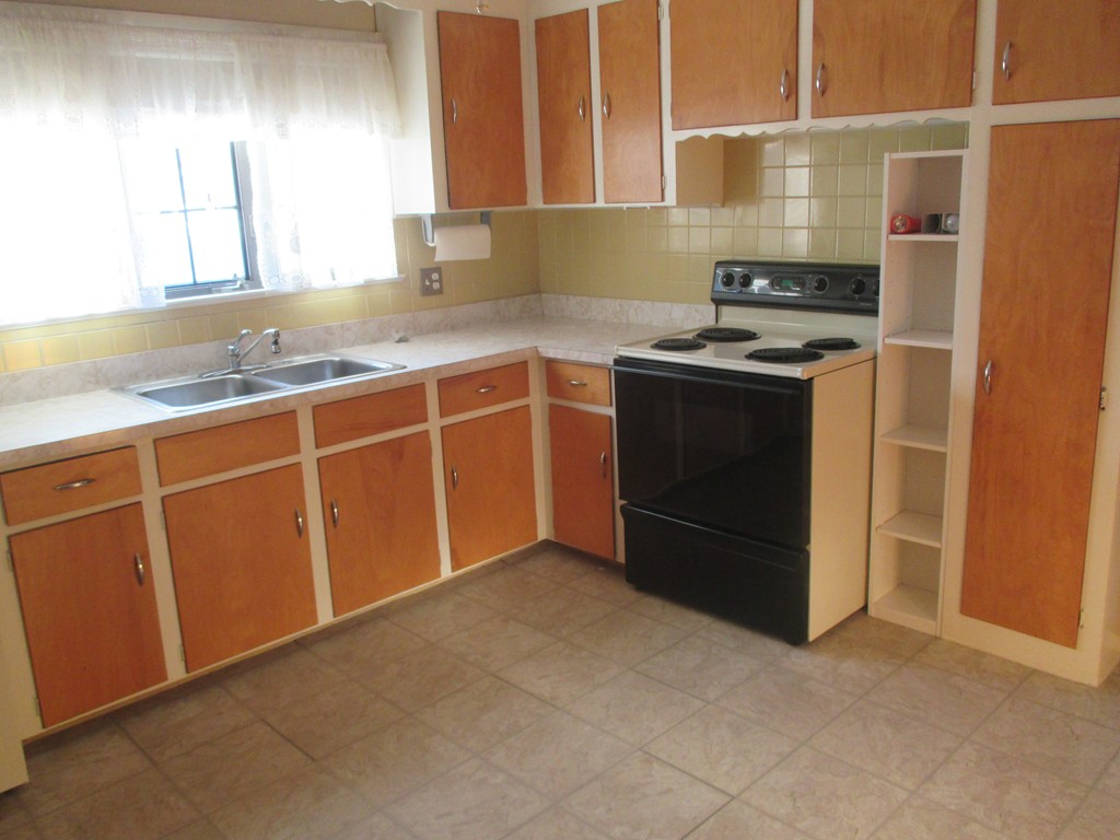 12 Locke Road Billerica, MA 01821 - Photo 3 of 16 a kitchen with granite countertop a sink and a stove