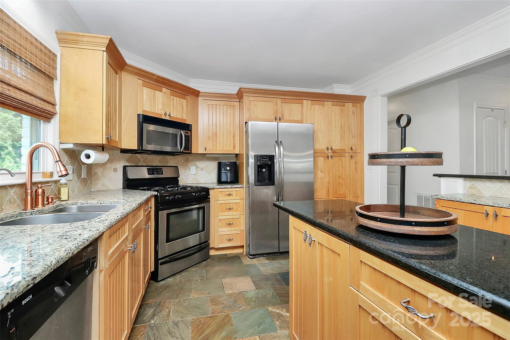 6500 Old Providence Road Charlotte, NC 28226 - Photo 11 of 40 a kitchen with stainless steel appliances granite countertop a sink stove and refrigerator