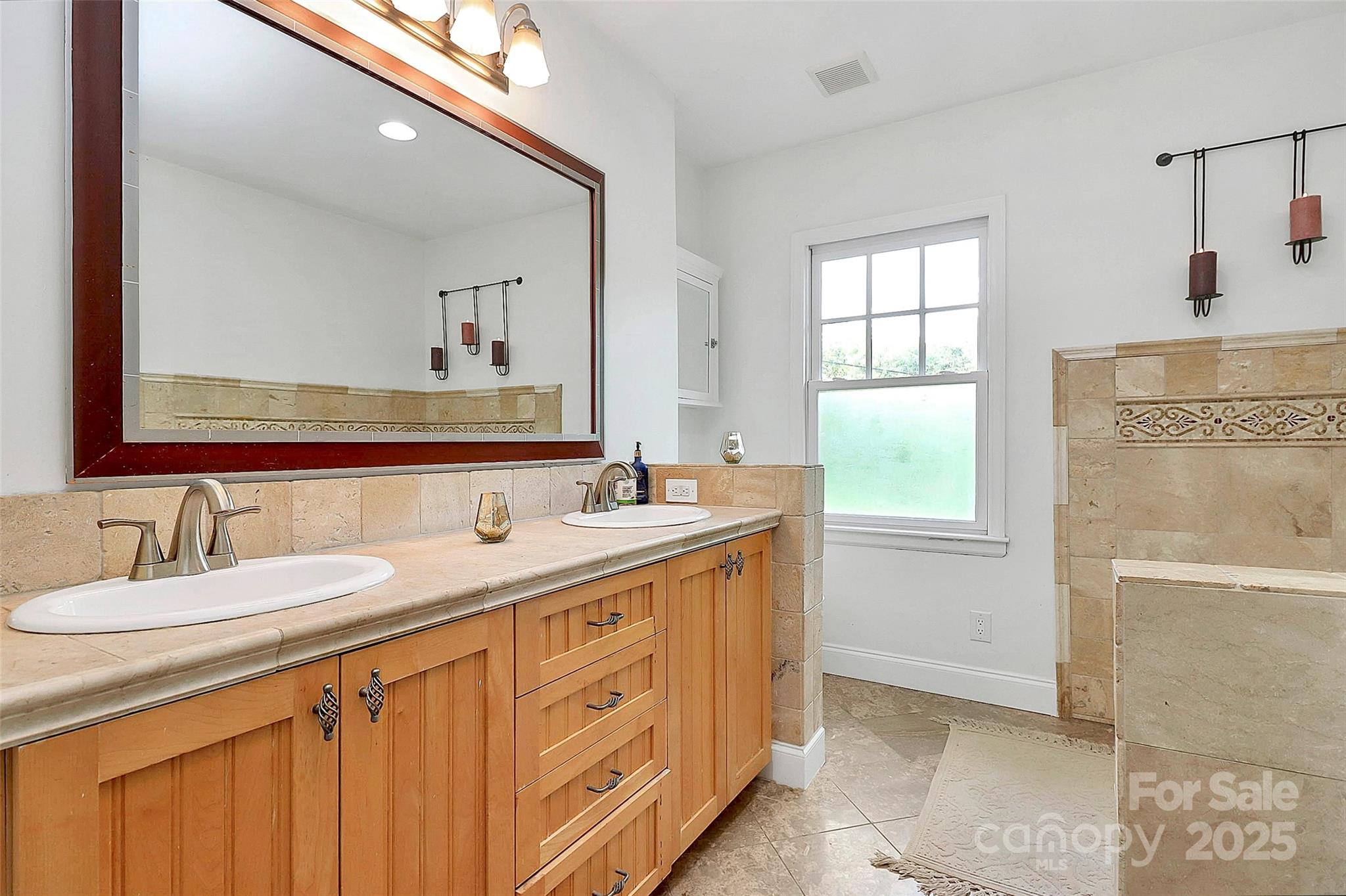 6500 Old Providence Road Charlotte, NC 28226 - Photo 19 of 40 a bathroom with a sink a vanity and a mirror